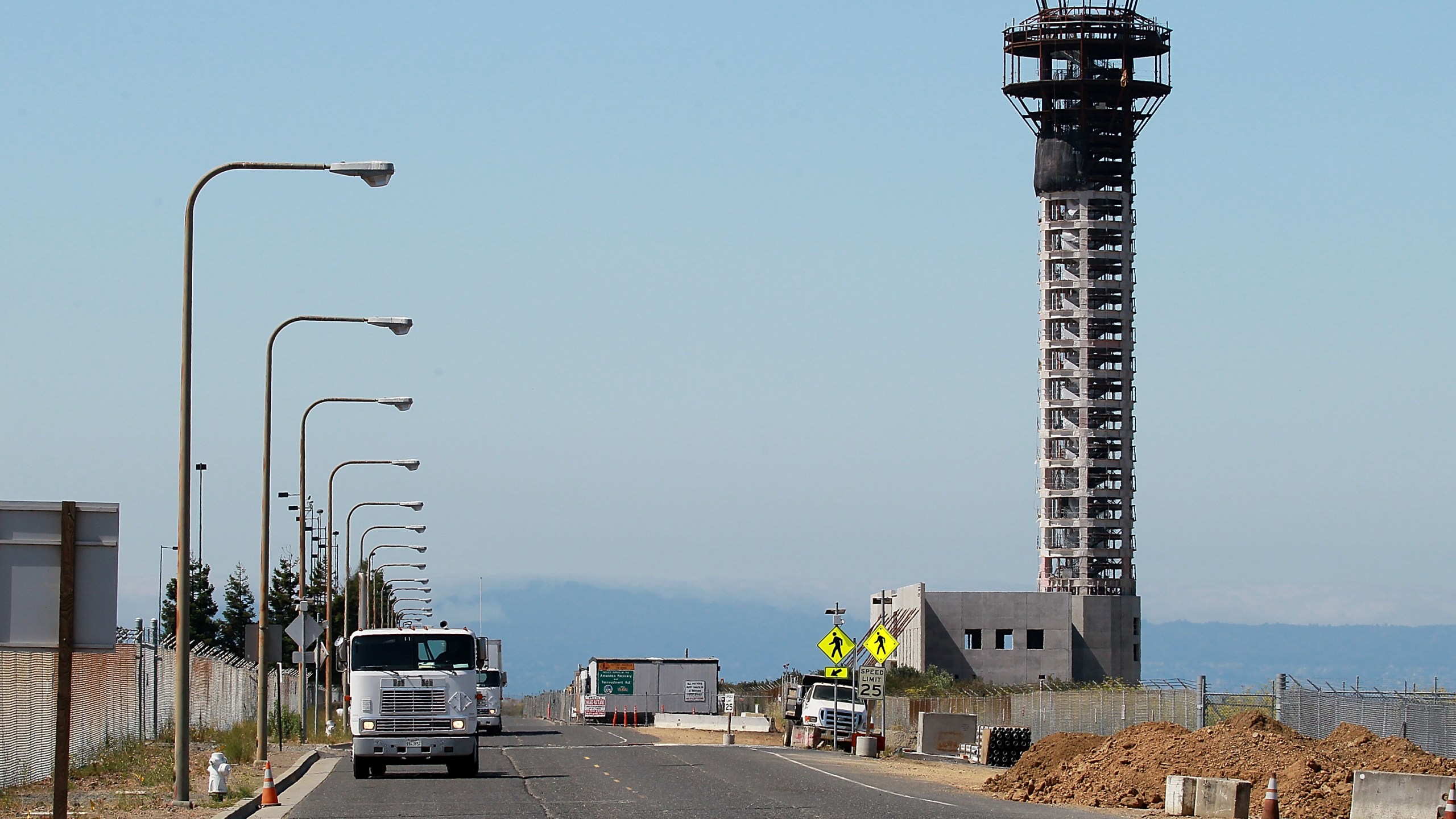 Trucks drive down a road near a half-completed 236-foot FAA control tower at Oakland International Airport on August 3, 2011 in Oakland. (Justin Sullivan/Getty Images)