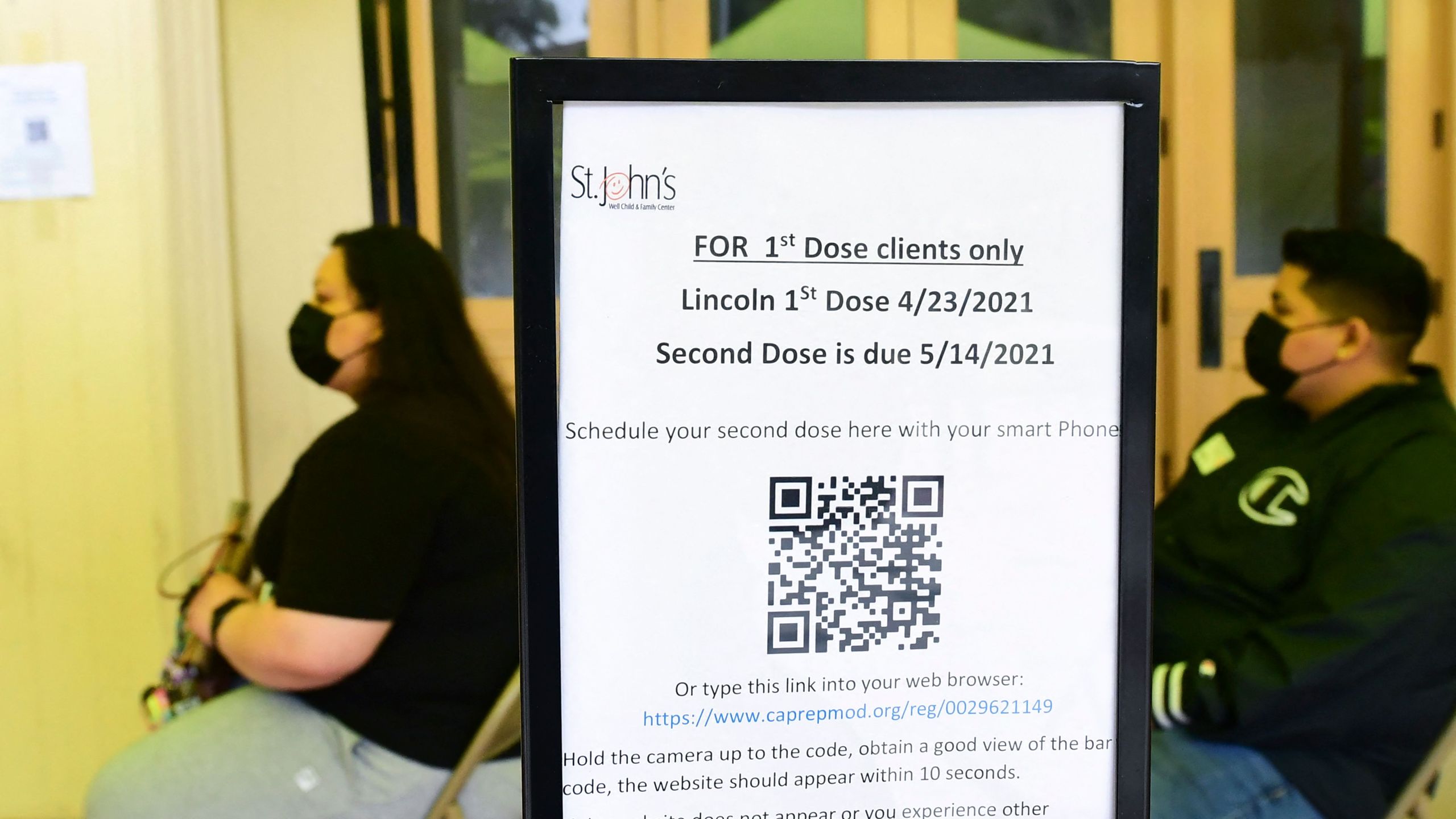 People wait their turn for the Pfizer Covid-19 vaccine administered by medical assistants from St. John's Well Child and Family Center at Abraham Lincoln High School in Los Angeles, on April 23, 2021. (FREDERIC J. BROWN/AFP via Getty Images)