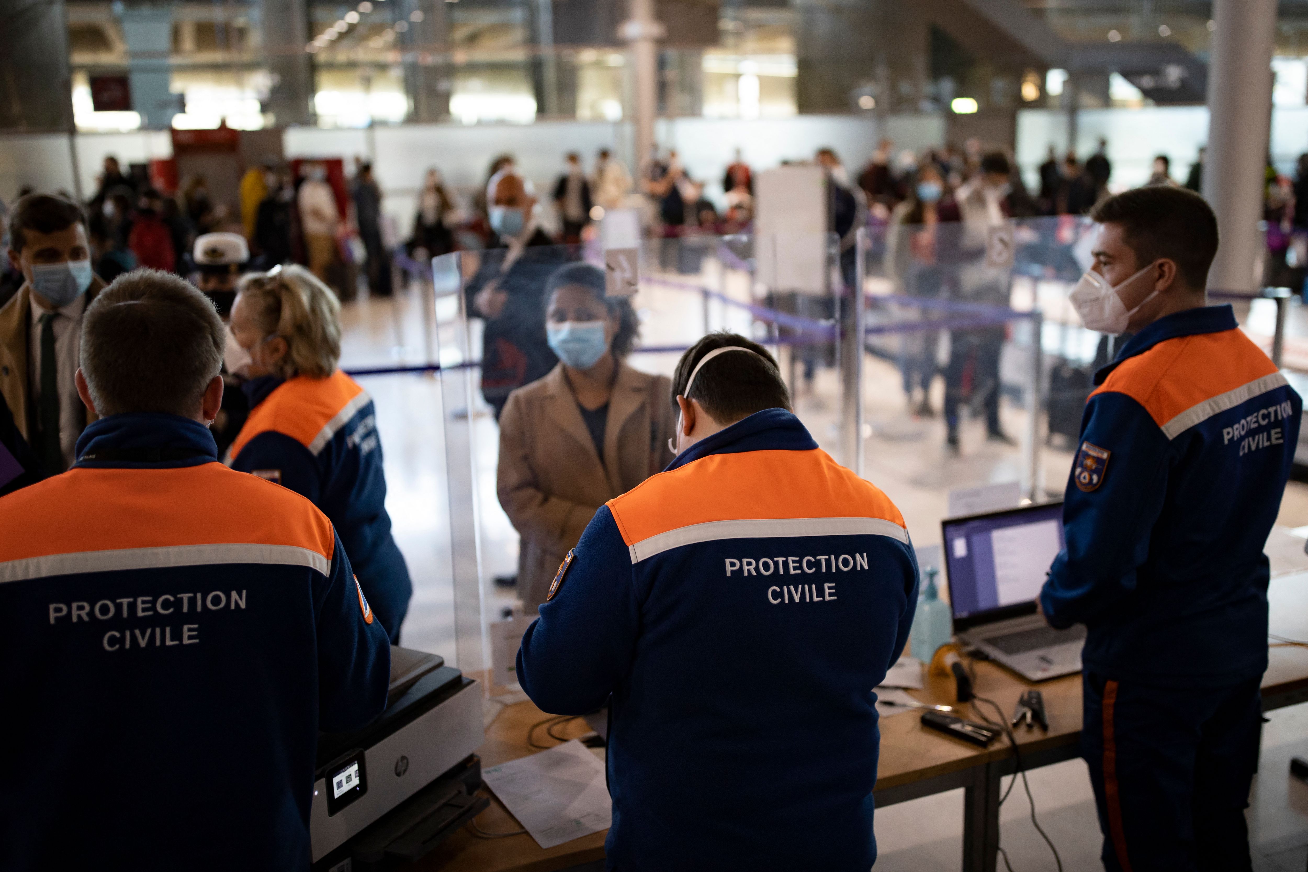 Passengers arriving from countries listed as COVID-19 red zones register for coronavirus tests upon their arrival at Roissy Charles de Gaulle airport in Roissy, near Paris, on April 25, 2021.(IAN LANGSDON/POOL/AFP via Getty Images)