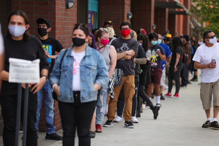 Customers wait in line on Hollywood Boulevard on April 1, 2021 in Los Angeles. (Rich Fury/Getty Images)