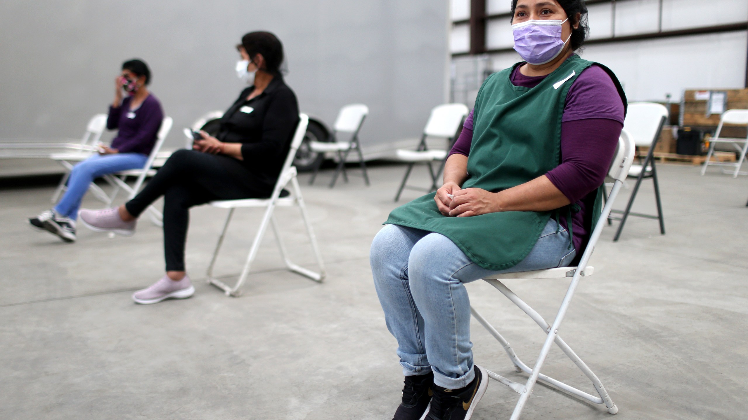 Workers sit in the observation area after receiving a one shot dose of the Johnson & Johnson COVID-19 vaccine at a clinic geared toward agriculture workers organized by TODEC on April 05, 2021 in Riverside, California. (Mario Tama/Getty Images)