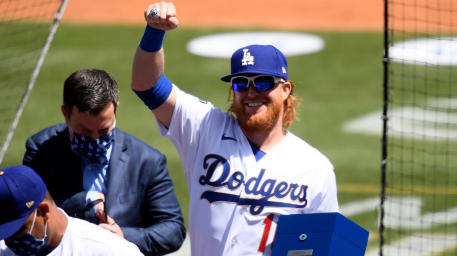 Justin Turner #2 of the Los Angeles Dodgers acknowledges the crowd after receiving his World Series ring prior to the game against the Washington Nationals at Dodger Stadium on April 9, 2021 in Los Angeles. (Harry How/Getty Images)