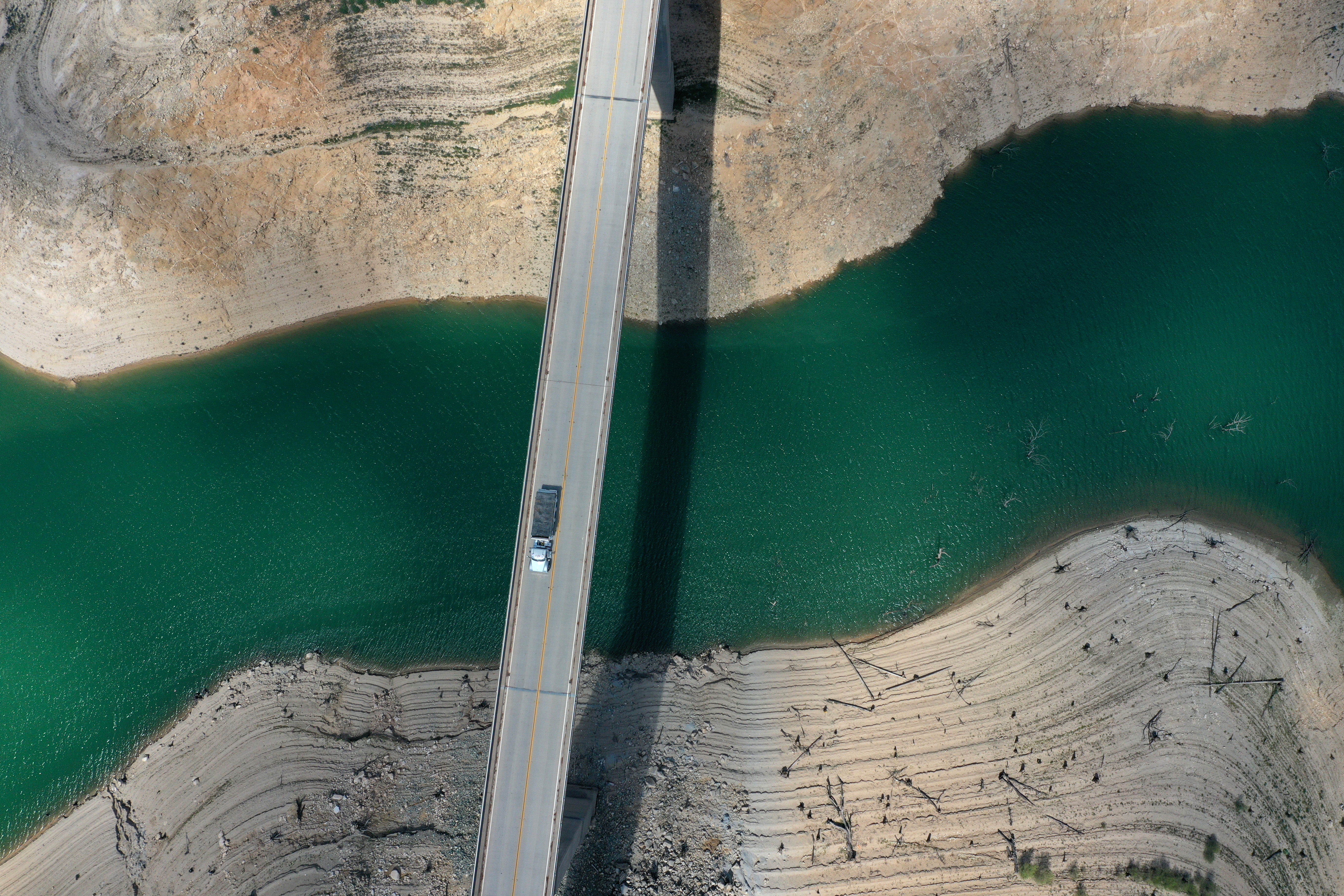 In an aerial view, a truck drives on the Enterprise Bridge over a section of Lake Oroville on April 27, 2021 in Oroville. Justin Sullivan/Getty Images)