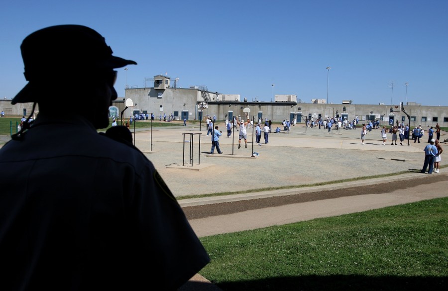 A California Department of Corrections officer looks on as inmates at the Mule Creek State Prison exercise in the yard August 28, 2007, in Ione. (Justin Sullivan/Getty Images)