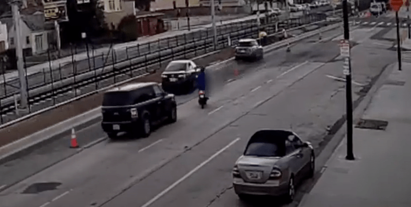 A photo taken from surveillance video released by LAPD shows the moment before a hit-and-run driver struck a moped in Leimert Park on April 1, 2021.