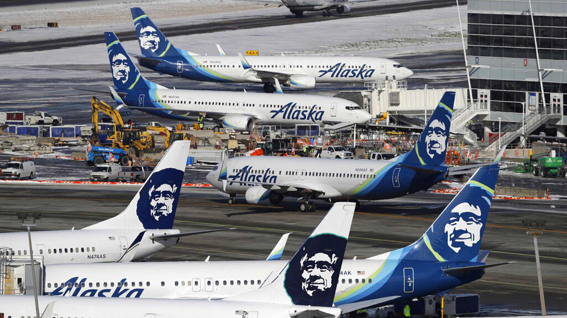 In this Feb. 5, 2019, file photo, Alaska Airlines planes are parked at a gate area at Seattle-Tacoma International Airport in Seattle. AP Photo/Ted S. Warren, File)