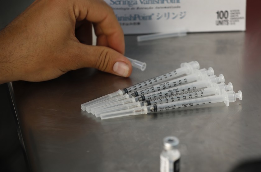 Researchers are studying ways to deliver COVID-19 vaccines as a capsule, tablet or nasal spray, rather than through injection. Above, doses of the Pfizer vaccine.(Al Seib / Los Angeles Times)