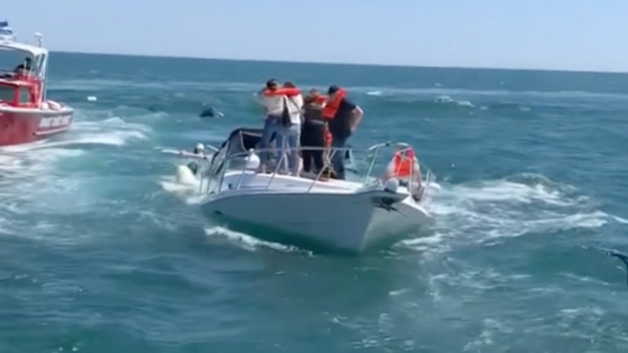 Video shared by the Orange County Sheriff's Department shows 14 people being rescued from a sinking boat off Newport Harbor on April 19, 2021.