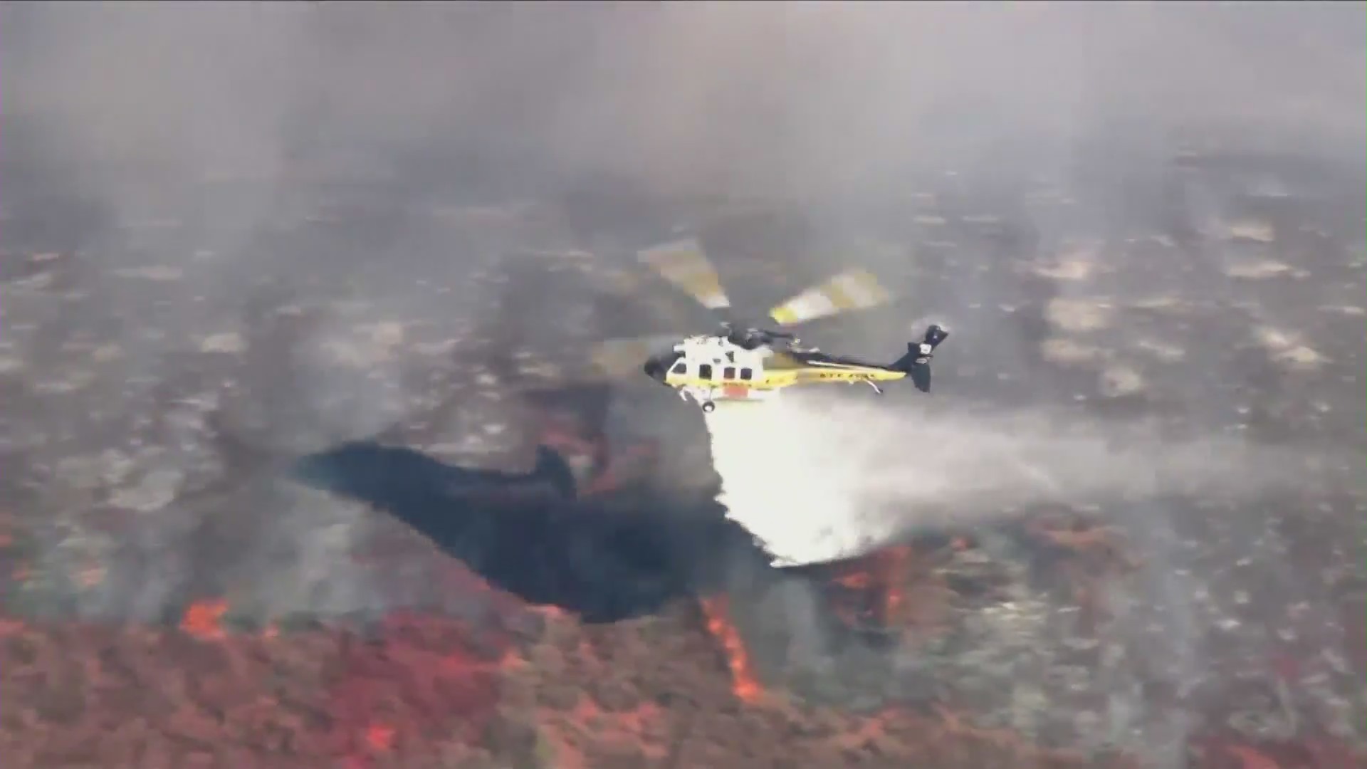 A helicopter makes a drop on the Country Fire in Thousand Oaks on April 29, 2021. (KTLA)