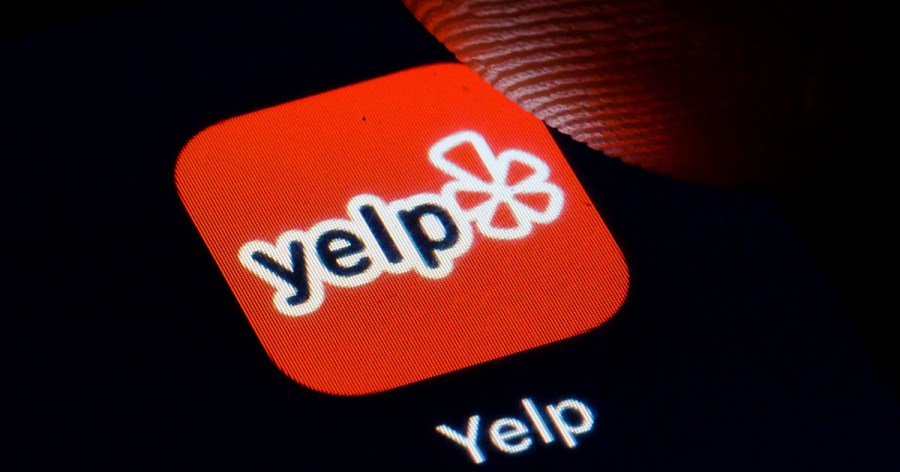 The Yelp logo is displayed on a smartphone on November 27, 2019 in Berlin, Germany. (Thomas Trutschel/Photothek via Getty Images)