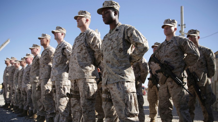 In this Jan. 15, 2018, file photo, U.S. Marines watch during the change of command ceremony at Task Force Southwest military field in Shorab military camp of Helmand province, Afghanistan. (AP Photo/Massoud Hossaini, File)