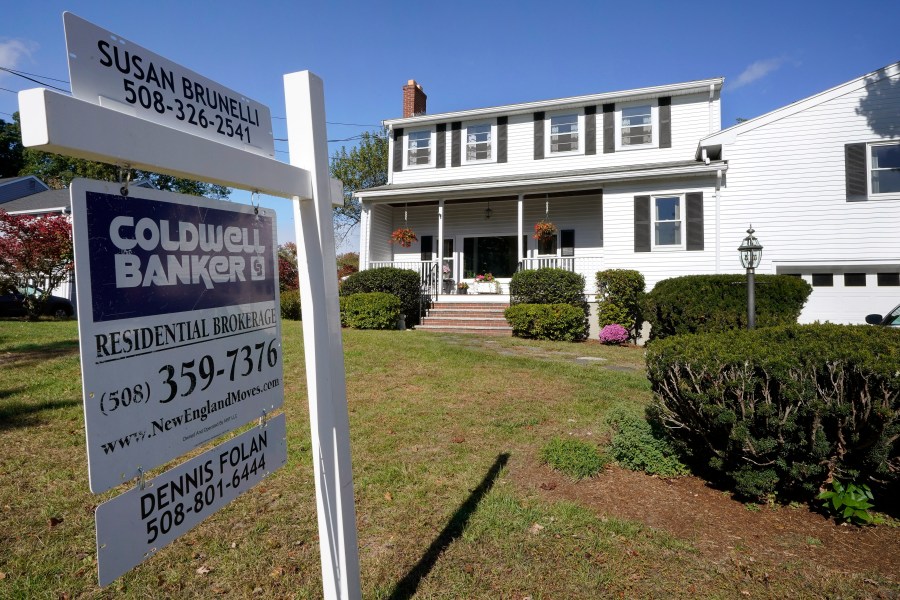 In this Oct. 6, 2020 file photo, a real estate brokerage sign stands in front of a house in Norwood, Mass. (AP Photo/Steven Senne)