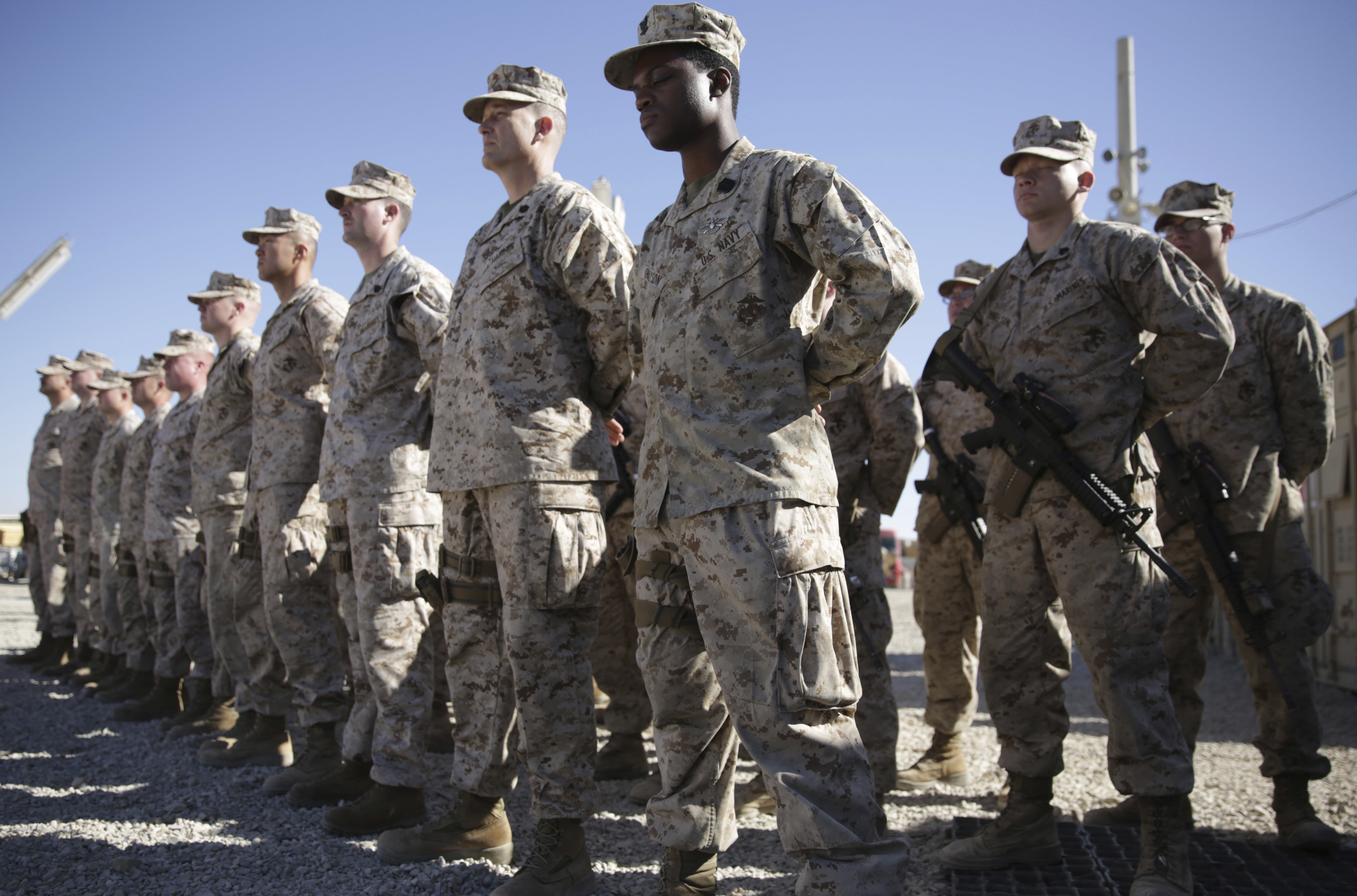 In this Jan. 15, 2018, file photo, U.S. Marines watch during the change of command ceremony at Task Force Southwest military field in Shorab military camp of Helmand province, Afghanistan.(AP Photo/Massoud Hossaini, File)