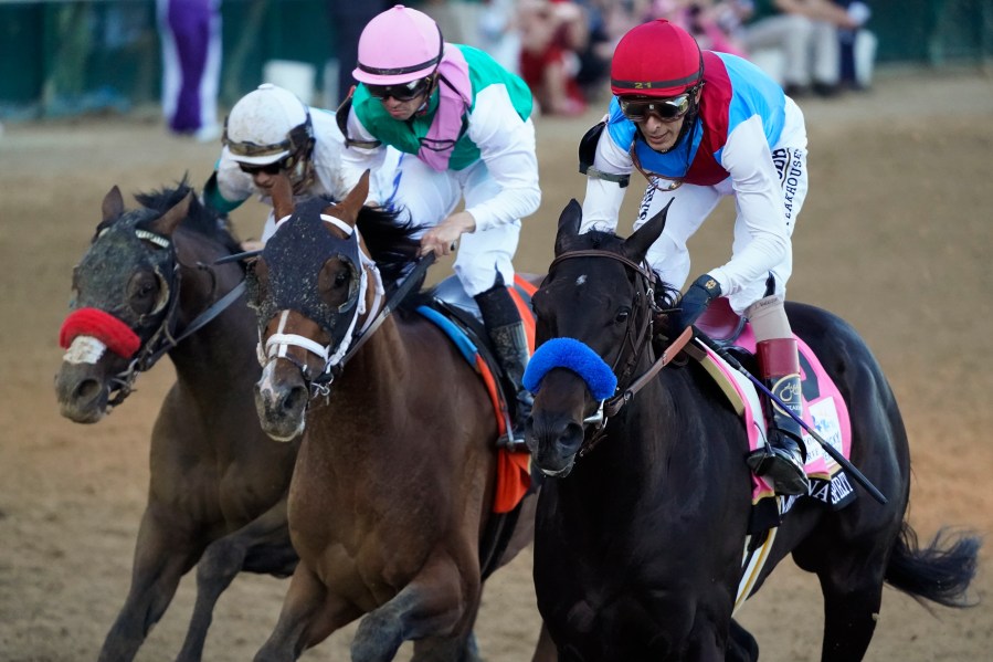 John Velazquez riding Medina Spirit leads Florent Geroux on Mandaloun and Flavien Prat riding Hot Rod Charlie to win the 147th running of the Kentucky Derby at Churchill Downs, Saturday, May 1, 2021, in Louisville, Ky. (AP Photo/Jeff Roberson)