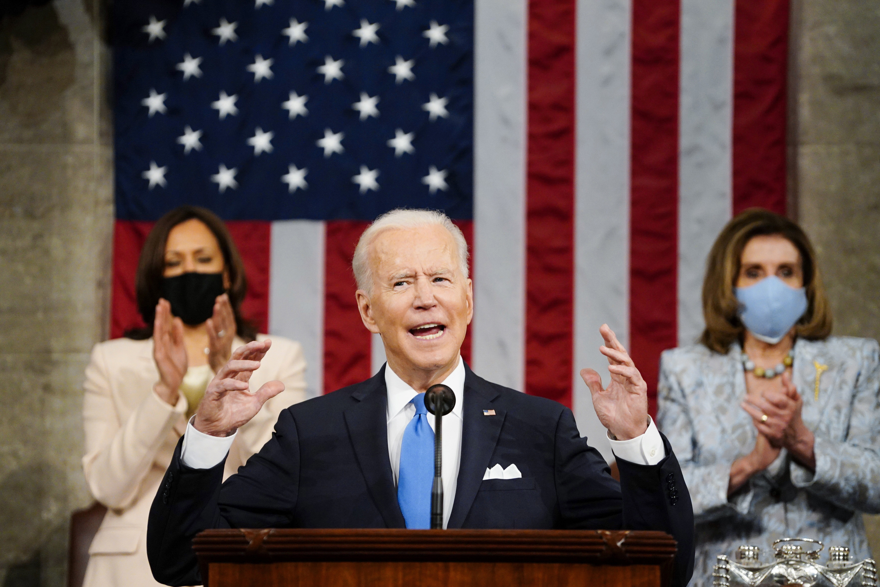 In this Wednesday, April 28, 2021, file photo, U.S. President Joe Biden addresses a joint session of Congress in the House Chamber at the U.S. Capitol as Vice President Kamala Harris, left, and House Speaker Nancy Pelosi of Calif., applaud, in Washington. (Melina Mara/Pool Photo via AP, File)