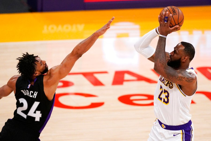 Los Angeles Lakers forward LeBron James, right, shoots as Toronto Raptors center Khem Birch defends during the first half of an NBA basketball game Sunday, May 2, 2021, in Los Angeles. (AP Photo/Mark J. Terrill)