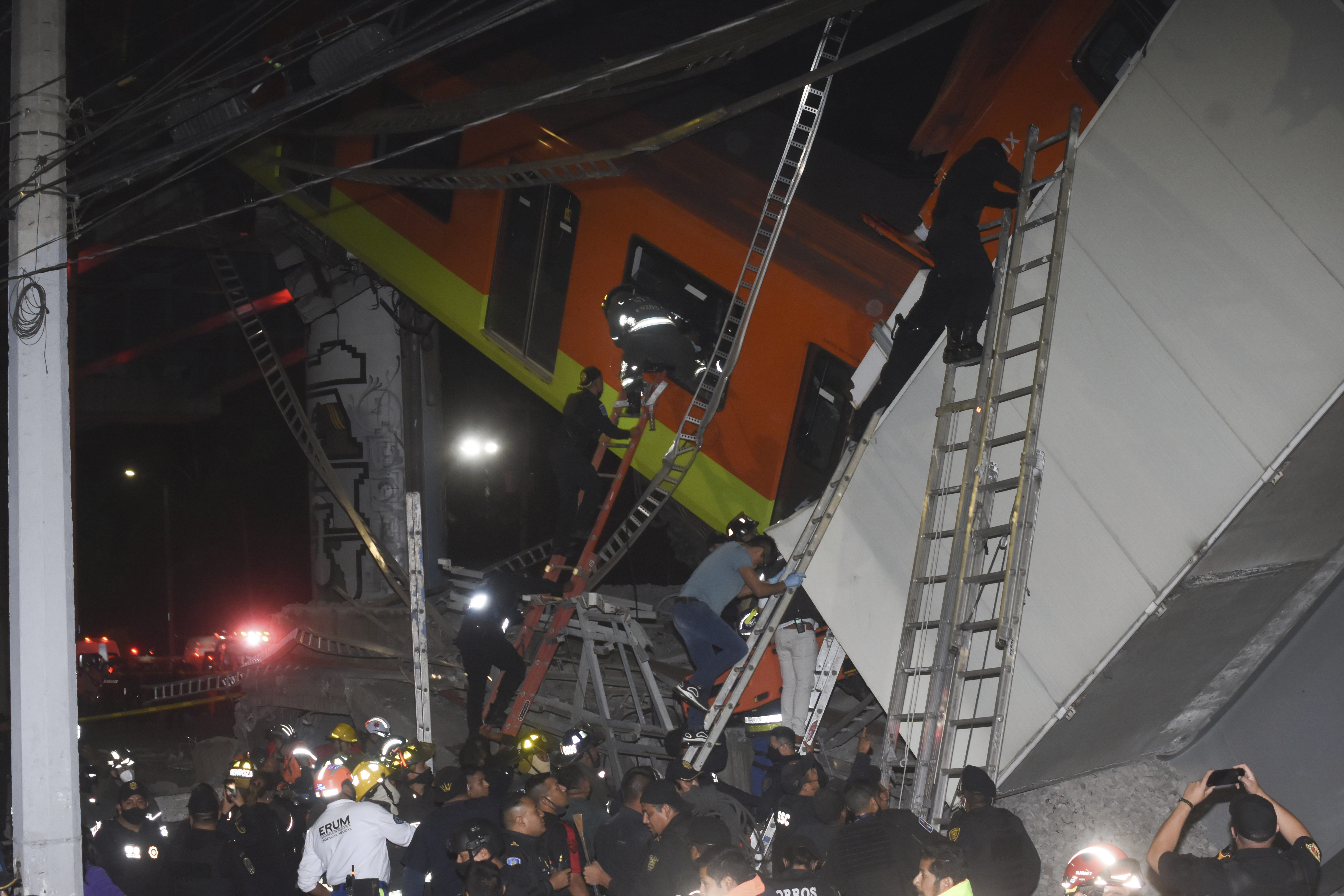 Mexico City firefighters and rescue personnel work to recover victims from a subway car that fell after a section of Line 12 of the subway collapsed in Mexico City on May 3, 2021. (Jose Ruiz/Associated Press)