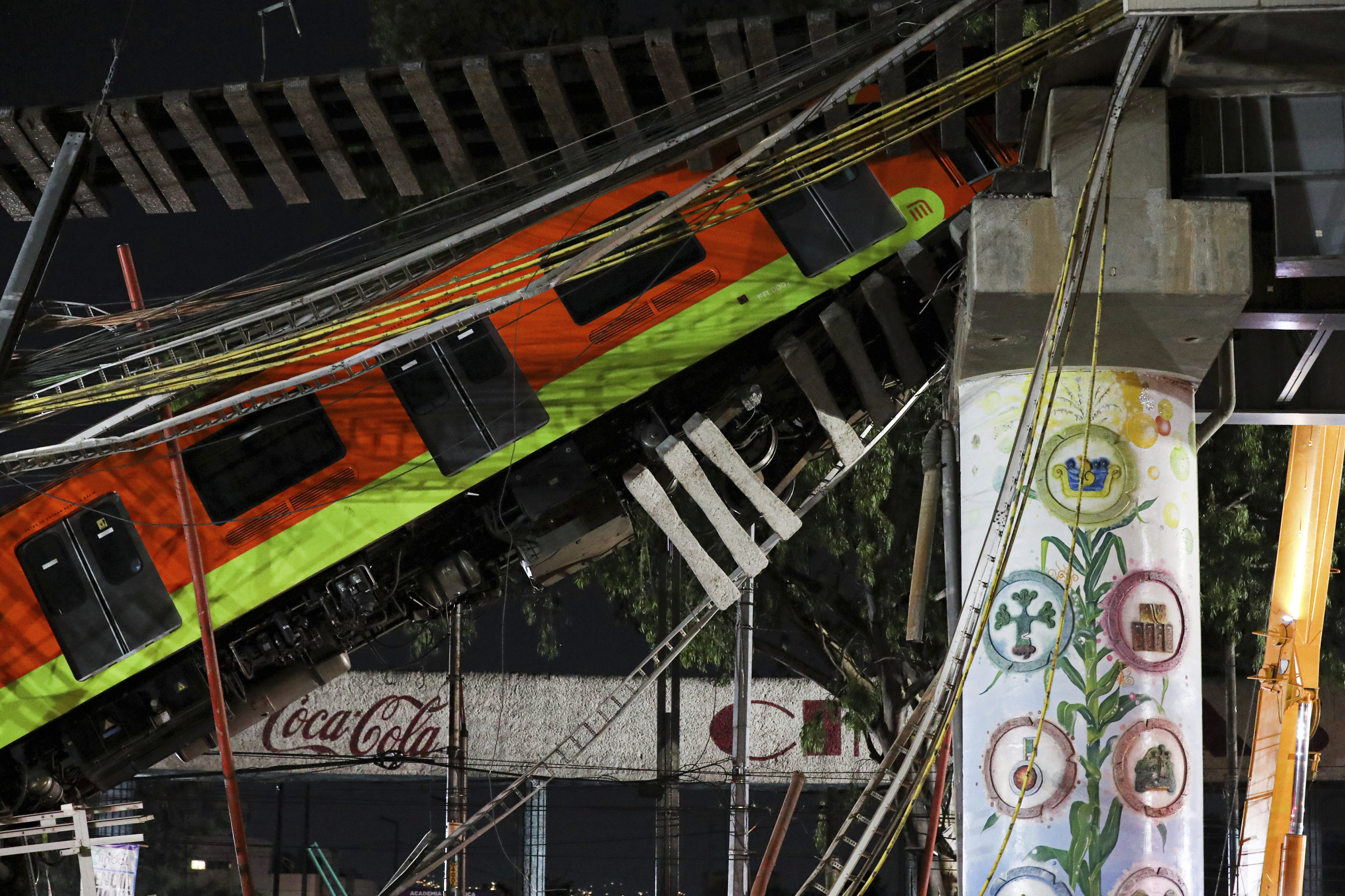 Mexico City's subway cars lay at an angle after a section of Line 12 of the subway collapsed in Mexico City on May 4, 2021. (Marco Ugarte / Associated Press)