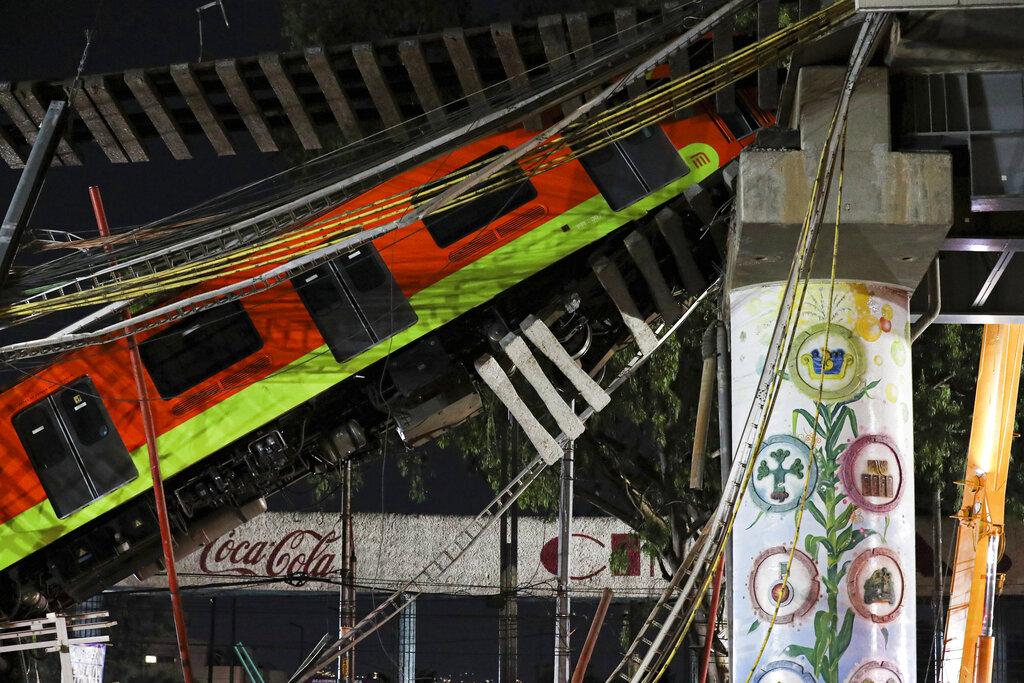 Mexico City's subway cars lay at an angle after a section of Line 12 of the subway collapsed in Mexico City, Tuesday, May 4, 2021. (AP Photo/Marco Ugarte)