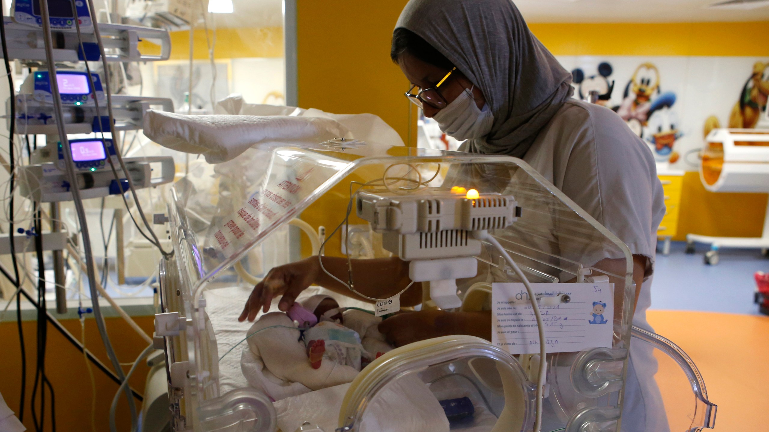 A Moroccan nurse takes care of one of the nine babies protected in an incubator at the maternity ward of the private clinic of Ain Borja in Casablanca, Morocco, Wednesday, May 5, 2021. A Malian woman gave birth to nine babies after n ' to have waited only seven, announced Wednesday the Ministry of Health of Mali. . Halima CissÈ, 25, gave birth by caesarean section Tuesday in Morocco after being sent there for special care, the ministry said. (AP Photo / Abdeljalil Bounhar)