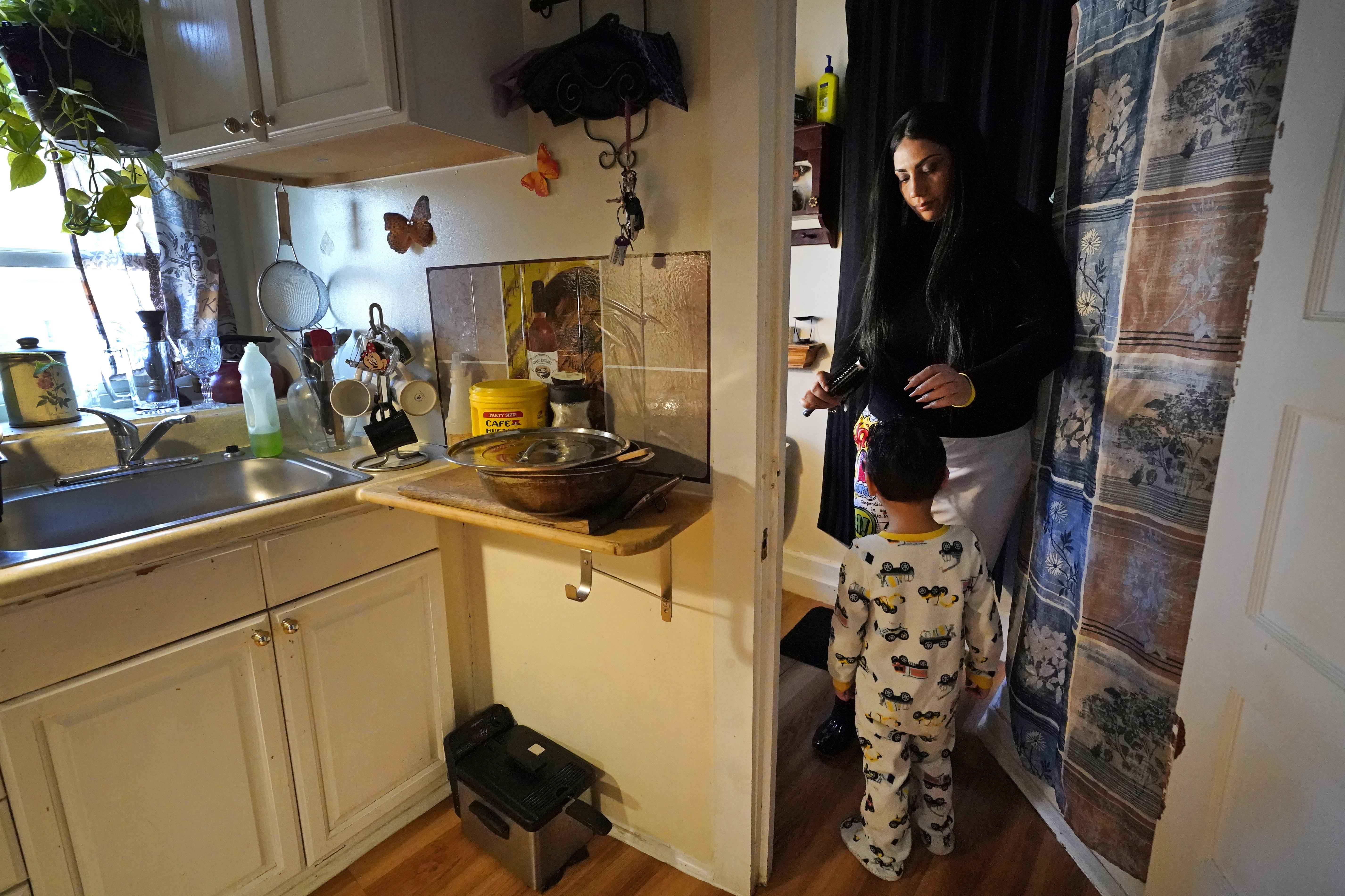 In this March 10, 2021, file photo, Isabel Miranda brushes the hair of her 4-year-old son, Julian, in their rental apartment in Haverhill, Mass. A federal judge has ruled, Wednesday, May 5, 2021, that the Centers for Disease Control exceeded its authority when it imposed a federal eviction moratorium to provide protection for renters out of concern that having families lose their homes and move into shelters or share crowded conditions with relatives or friends during the pandemic would further spread the highly contagious virus. Miranda and her family would no longer have this eviction protection if this ruling stands. (AP Photo/Elise Amendola, File)