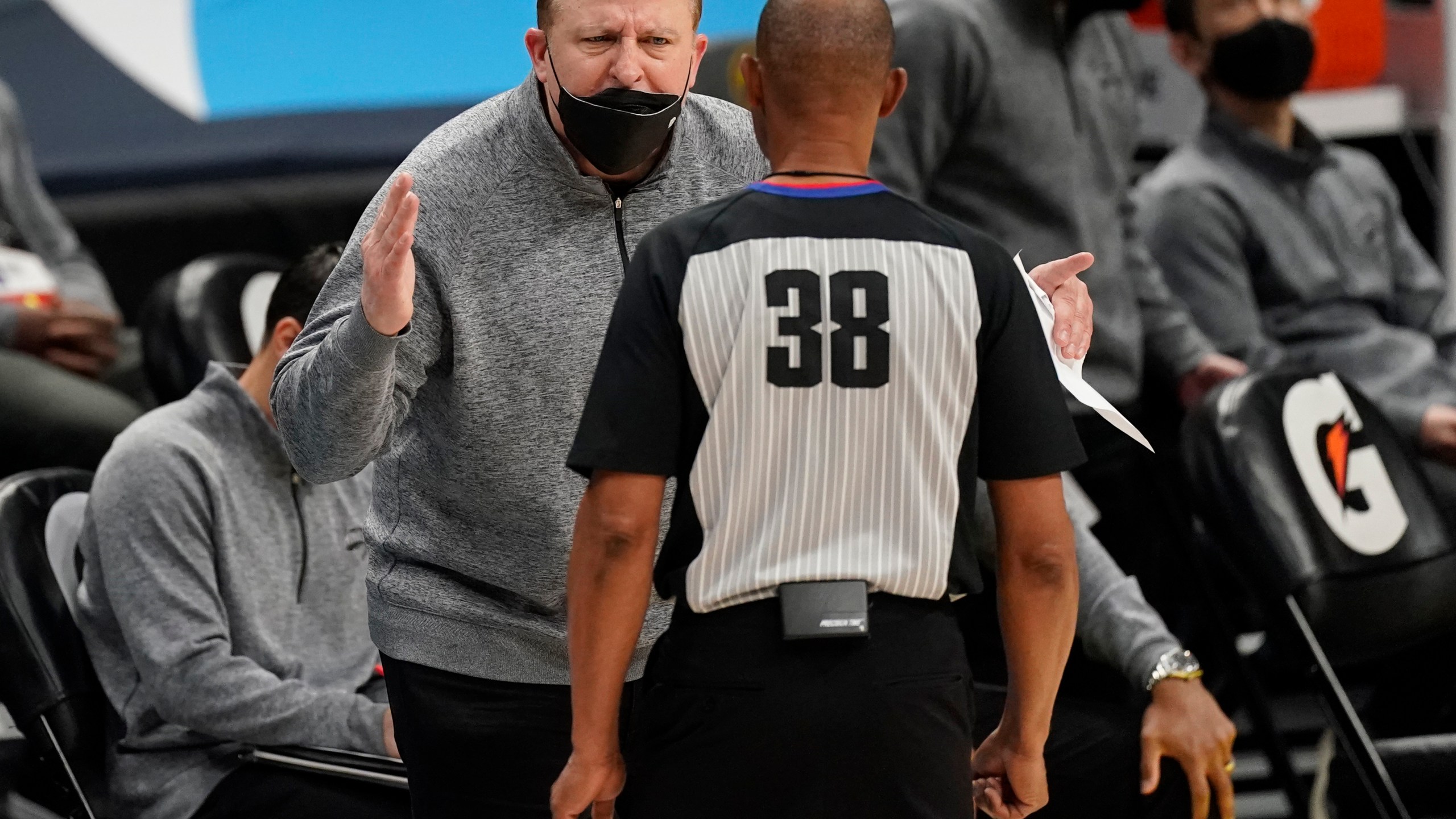 New York Knicks head coach Tom Thibodeau, back, argues for a call with referee Michael Smith in the second half of an NBA basketball game against the Denver Nuggets Wednesday, May 5, 2021, in Denver. (AP Photo/David Zalubowski)