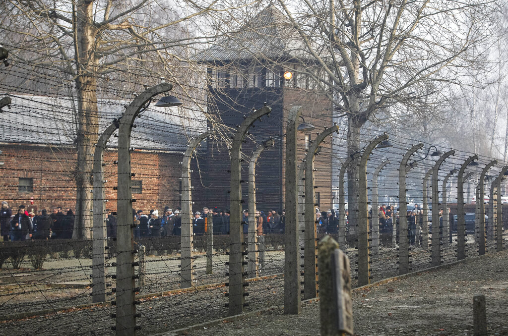 In this file photo taken Jan. 27, 2020, people are seen arriving at the site of the Auschwitz-Birkenau Nazi German death camp, where more than 1.1 million were murdered, in Oswiecim, Poland, for observances marking 75 years since the camp's liberation by the Soviet army. Needham, Massachusetts-based TripAdvisor on Thursday, May 6, 2021, faced criticism from the camp's museum and memorial after an author posted an inappropriate review of the museum on the TripAdvisor website, stating the reviewer visited to "test the chamber". The company originally declined to remove the message. (AP Photo/Czarek Sokolowski, FIle)