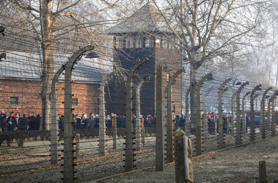 In this file photo taken Jan. 27, 2020, people are seen arriving at the site of the Auschwitz-Birkenau Nazi German death camp, where more than 1.1 million were murdered, in Oswiecim, Poland, for observances marking 75 years since the camp's liberation by the Soviet army. Needham, Massachusetts-based TripAdvisor on Thursday, May 6, 2021, faced criticism from the camp's museum and memorial after an author posted an inappropriate review of the museum on the TripAdvisor website, stating the reviewer visited to "test the chamber". The company originally declined to remove the message. (AP Photo/Czarek Sokolowski, FIle)