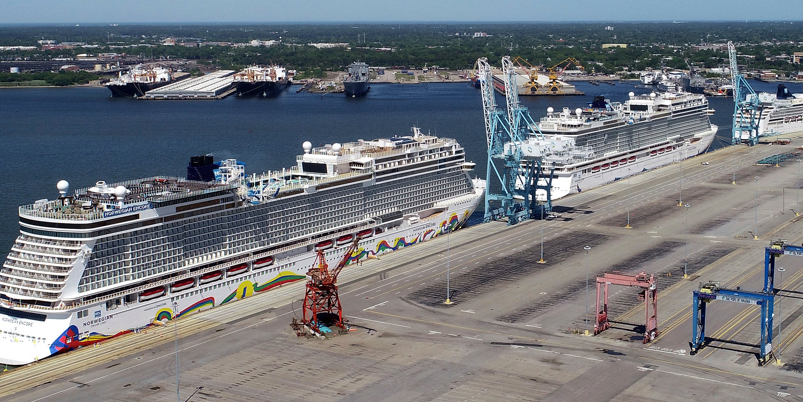 In this May 4, 2020 file photo, Norwegian cruise ships are docked at Portsmouth Marine Terminal in Portsmouth, Va. Norwegian Cruise Lines is threatening to skip Florida ports because of the governor's order banning businesses from requiring that customers be vaccinated against COVID-19. The company says Gov. Ron DeSantis' order conflicts with guidelines from federal health authorities that would let cruise ships sail in U.S. waters if passengers and crew members are vaccinated. (Stephen M. Katz/The Virginian-Pilot via AP, File)