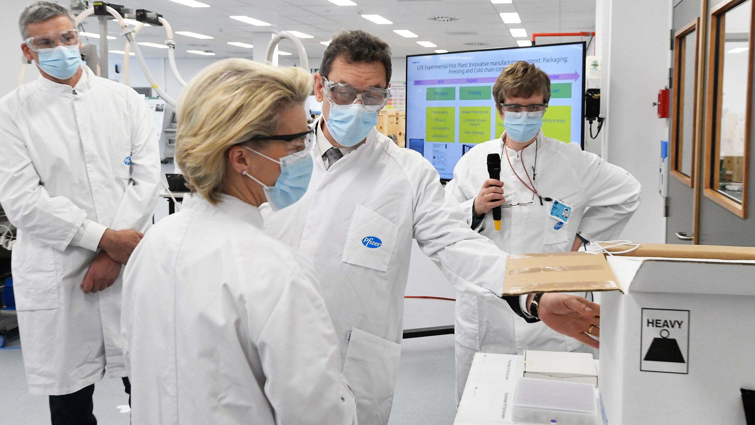 In this Friday, April 23, 2021 file photo, European Commission President Ursula von der Leyen, second left, speaks with Pfizer CEO Albert Bourla, center right, during an official visit to the Pfizer pharmaceutical company in Puurs, Belgium. (John Thys/Pool via AP, File)