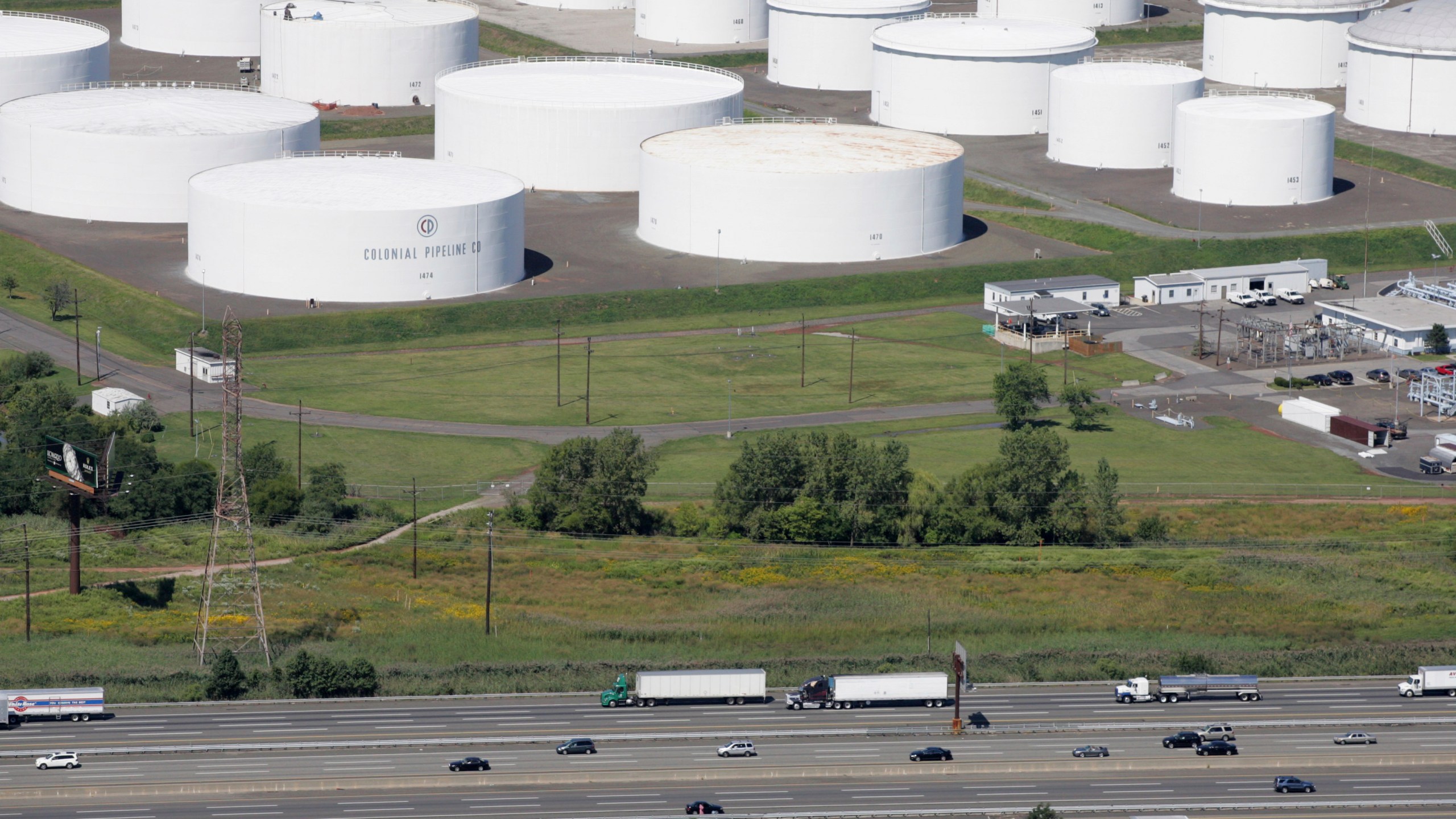 In this Sept. 8, 2008 file photo traffic on I-95 passes oil storage tanks owned by the Colonial Pipeline Company in Linden, N.J. (AP Photo/Mark Lennihan, File)