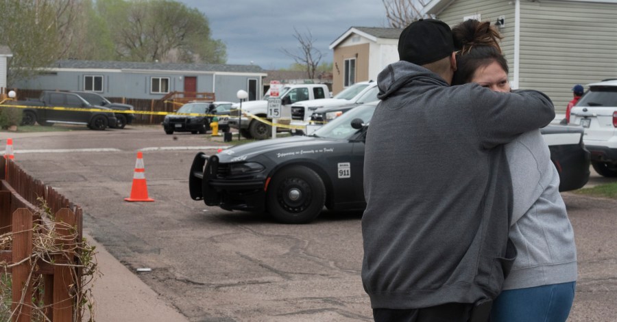 Family and friends of the victims who died in a shooting, comfort each down the street from the scene in Colorado Springs, Colo., on Sunday, May 9, 2021. The suspected shooter was the boyfriend of a female victim at the party attended by friends, family and children. He walked inside and opened fire before shooting himself, police said. Children at the attack weren’t hurt and were placed with relatives.(Jerilee Bennett/The Gazette via AP)