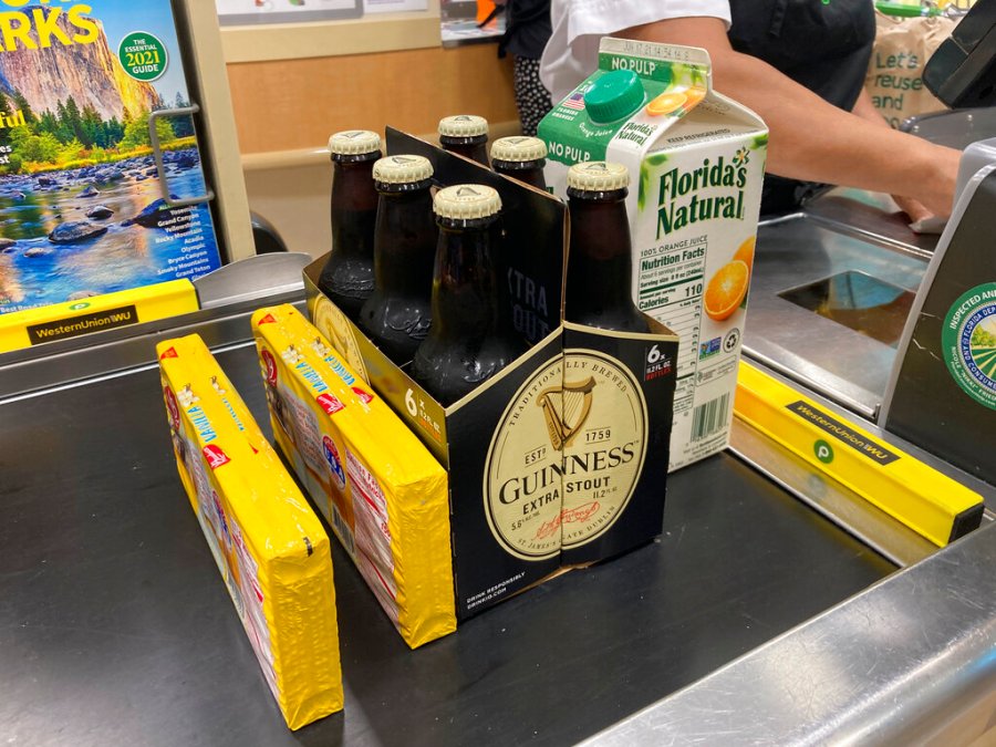 Groceries are shown at a checkout counter, Friday, April 16, 2021, at a grocery store in Surfside, Fla. (AP Photo/Wilfredo Lee)