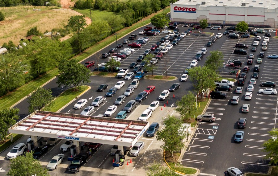 In this aerial image taken with a drone, numerous vehicles line up for gasoline at Costco on Wendover Avenue in Greensboro, N.C., on Tuesday, May 11, 2021. As the shutdown of a major fuel pipeline entered into its fifth day, efforts are under way to stave off potential fuel shortages, though no widespread disruptions were evident. The Colonial Pipeline, which delivers about 45% of the fuel consumed on the East Coast, was hit by a cyberattack on Friday. (Woody Marshall/News & Record via AP)