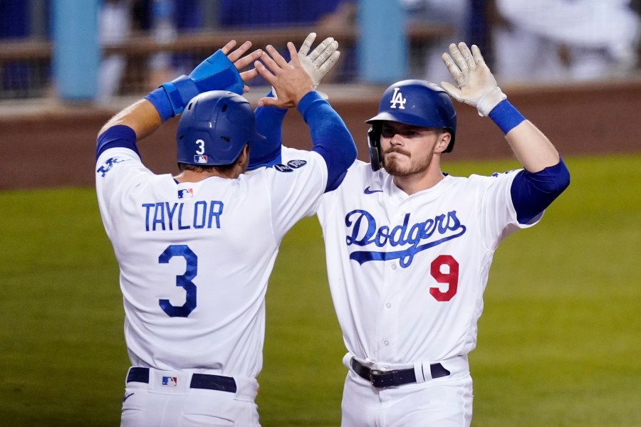 Los Angeles Dodgers' Gavin Lux, right, is congratulated by Chris Taylor after hitting a three-run home run during the eighth inning of an interleague baseball game against the Seattle Mariners on May 11, 2021, in Los Angeles. (AP Photo/Mark J. Terrill)