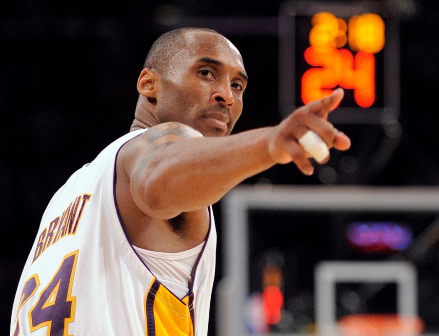 In this June 7, 2009, file photo, Los Angeles Lakers guard Kobe Bryant (24) points to a player behind him after making a basket in the closing seconds against the Orlando Magic in Game 2 of the NBA basketball finals, in Los Angeles. (AP Photo/Mark J. Terrill, File)