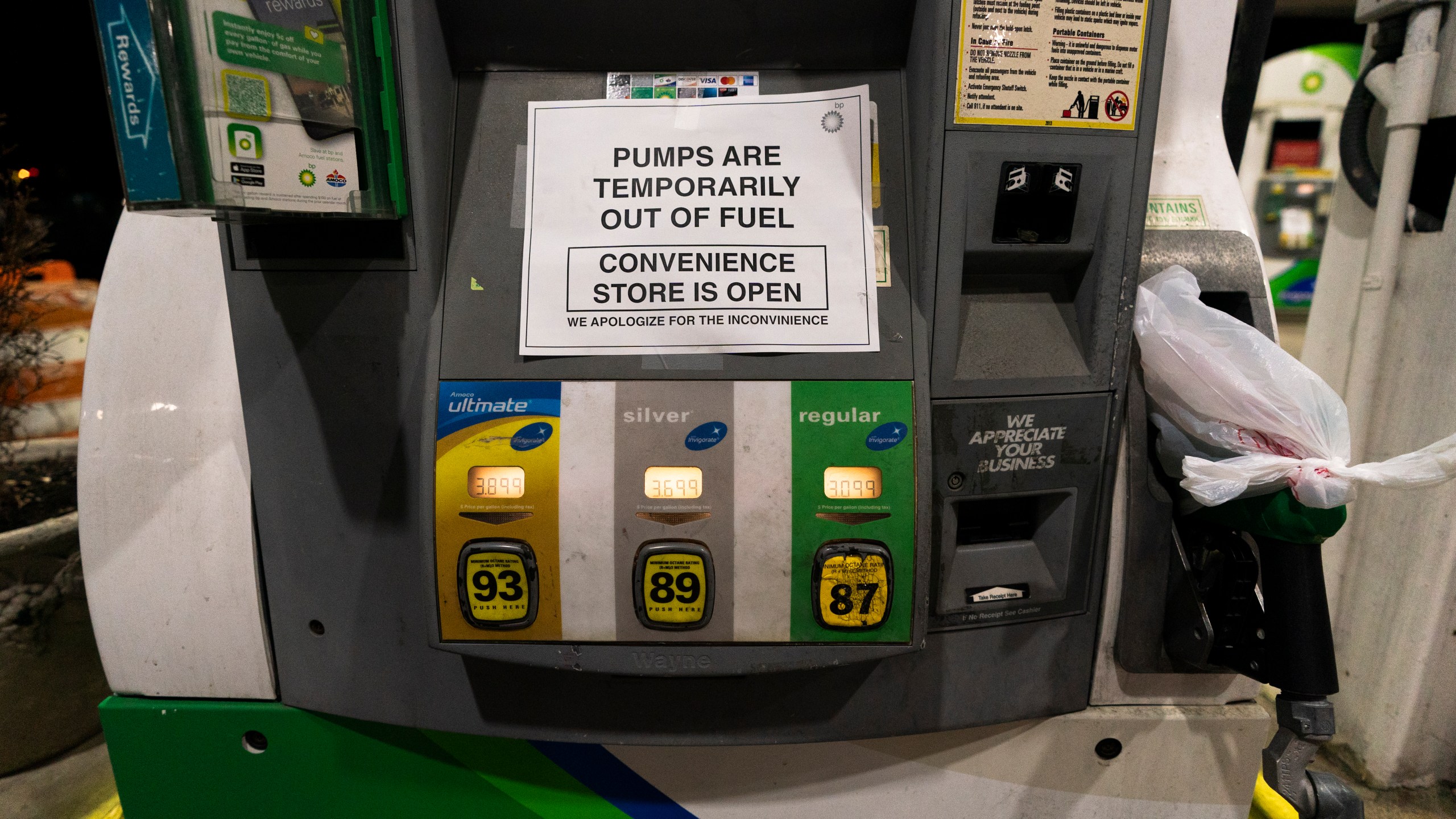 A gas pump at a gas station in Silver Spring, Md., is out of service, notifying customers they are out of fuel, late Thursday, May 13, 2021. Motorists found gas pumps shrouded in plastic bags at tapped-out service stations across more than a dozen U.S. states Thursday while the operator of the nation's largest gasoline pipeline reported making "substantial progress" in resolving the computer hack-induced shutdown responsible for the empty tanks. (AP Photo/Manuel Balce Ceneta)