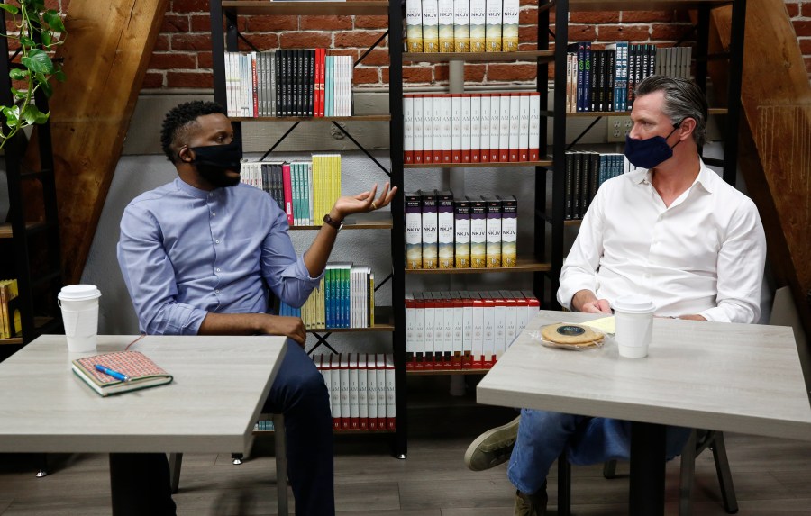 Then-Stockton Mayor Michael Tubbs, left, discusses his city with California Gov. Gavin Newsom, right, during a visit to Legendary Coffee and Books in Stockton on June 4, 2020. (Rich Pedroncelli / Associated Press)