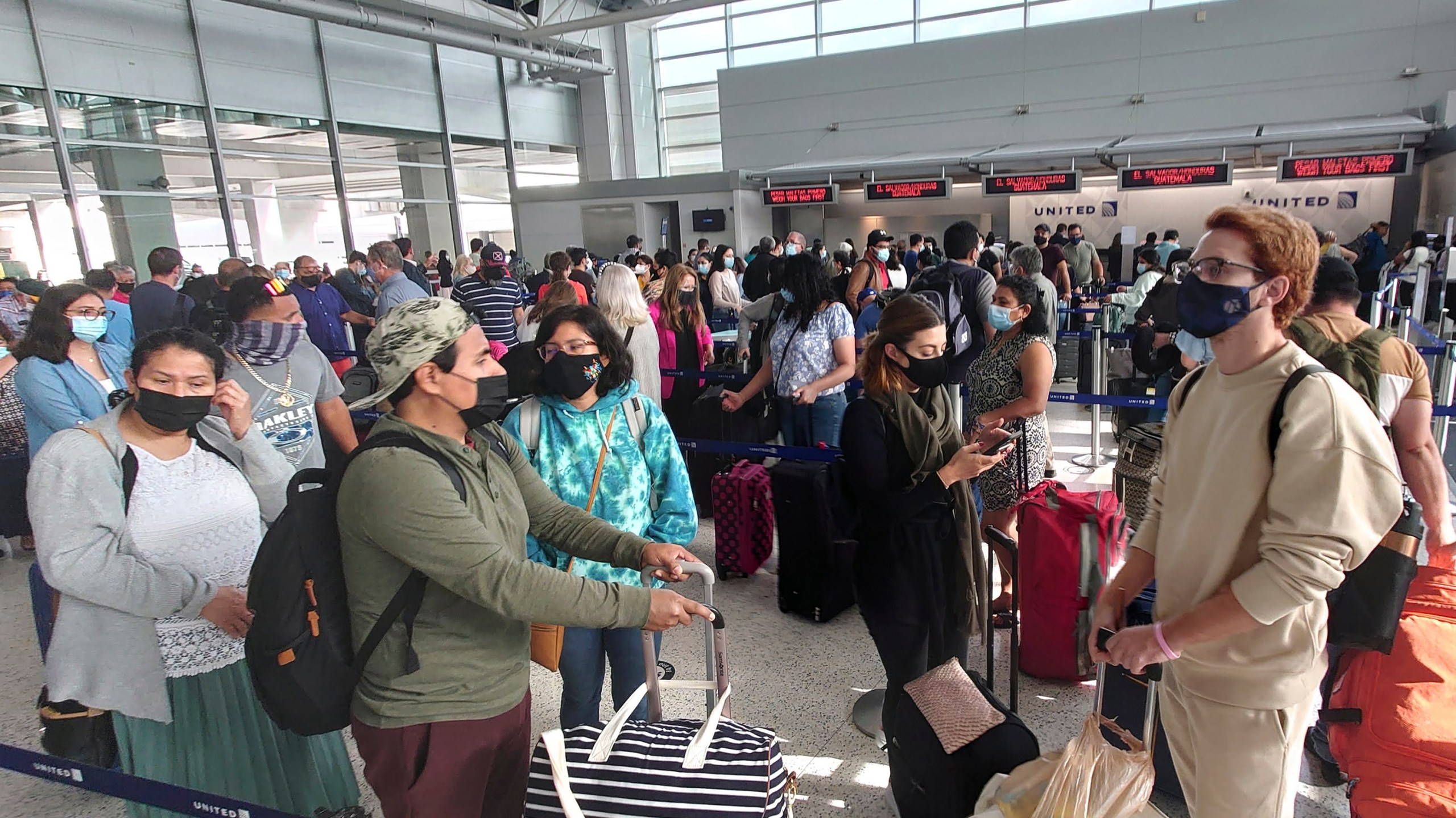 Airline passengers wait to check-in at George Bush Intercontinental Airport Sunday, May 16, 2021, in Houston. (AP Photo/David J. Phillip)