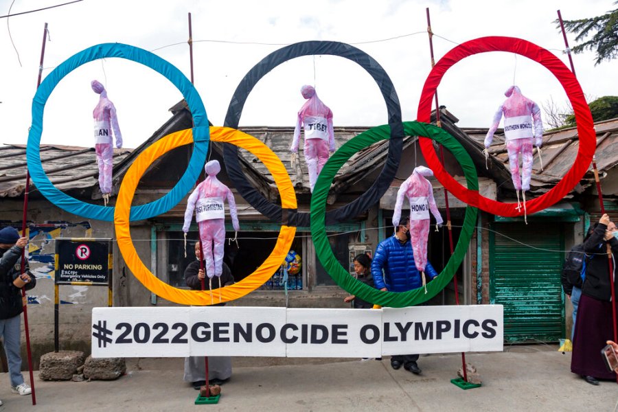 In this Feb. 3, 2021, file photo, exile Tibetans use the Olympic Rings as a prop as they hold a street protest against the holding of the 2022 Beijing Winter Olympics, in Dharmsala, India.