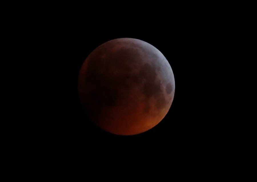 In this Monday, Jan. 21, 2019 file photo, the Earth's shadow falls across the full moon seen above Brighton, southeast England. The first total lunar eclipse in more than two years coincides with a supermoon this week for a cosmic show. This super “blood” moon will be visible Wednesday, May 26, 2021 across the Pacific _ offering the best viewing _ as well as the western half of North America, bottom of South America and eastern Asia. (AP Photo/Alastair Grant, File)