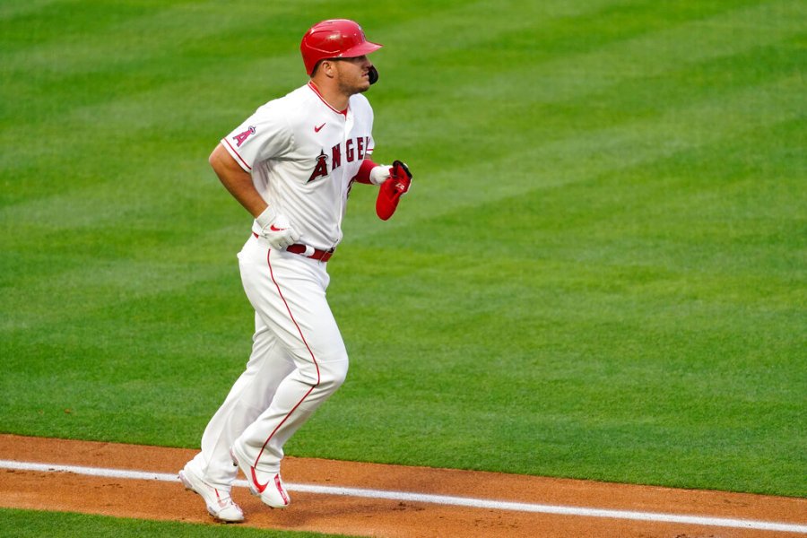 Los Angeles Angels' Mike Trout (27) is walked by Cleveland Indians starting pitcher Sam Hentges during the first inning of a baseball game Monday, May 17, 2021, in Los Angeles. (AP Photo/Ashley Landis)