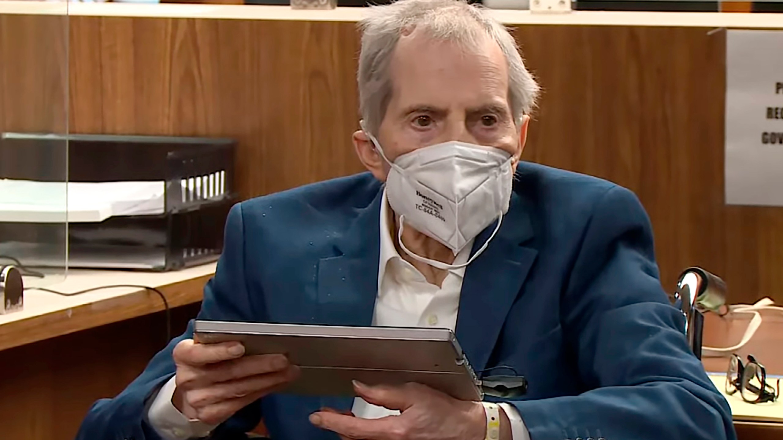 In this still image taken from the Law & Crime Network court video, real estate heir Robert Durst watches as Deputy District Attorney John Lewin presents a new round of opening statements in the murder case against Durst after a 14-month recess due to the coronavirus pandemic in Los Angeles County Superior Court in Inglewood on May 18, 2021. (Law & Crime Network via Associated Press, Pool)