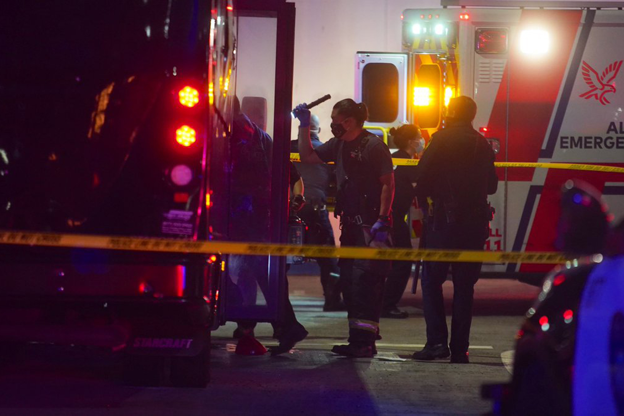 Oakland police and fire attend to multiple people who were injured in a shooting involving a party bus in East Oakland, Calif., on Tuesday, May 18, 2021. (Dylan Bouscher/Bay Area News Group via AP)