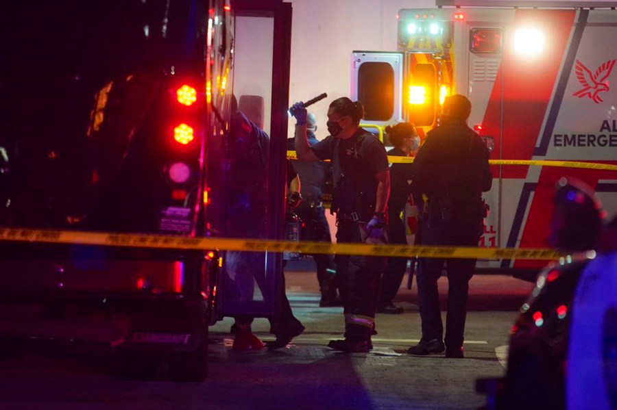 Oakland police and fire attend to multiple people who were injured in a shooting involving a party bus in East Oakland, Calif., on Tuesday, May 18, 2021. (Dylan Bouscher/Bay Area News Group via AP)