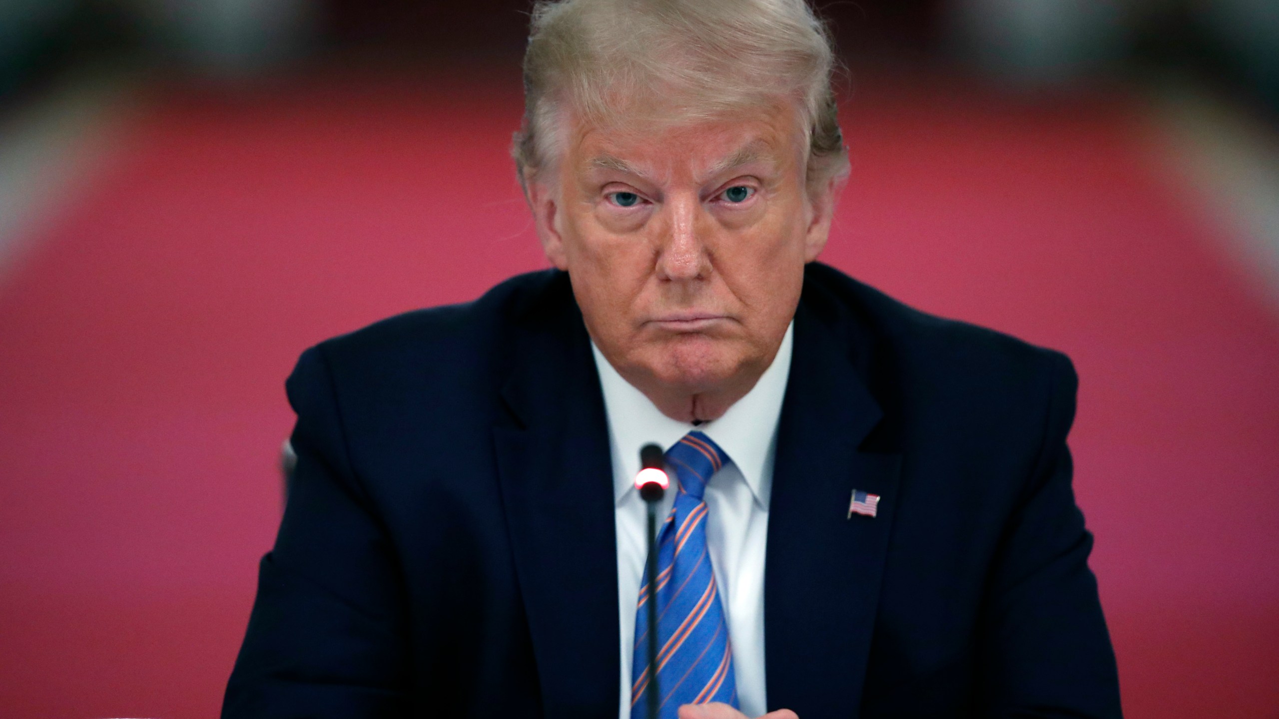 In this Tuesday, July 7, 2020 file photo, President Donald Trump listens during a "National Dialogue on Safely Reopening America's Schools," event in the East Room of the White House in Washington. The New York attorney general’s office said Tuesday, May 18, 2021 that it is conducting a criminal investigation into former President Donald Trump’s business empire, expanding what had previously been a civil probe. Attorney General Letitia James investigators are working with the Manhattan district attorney’s office, which has been conducting a criminal investigation into Trump and his company, the Trump Organization, for two years. (AP Photo/Alex Brandon, File)