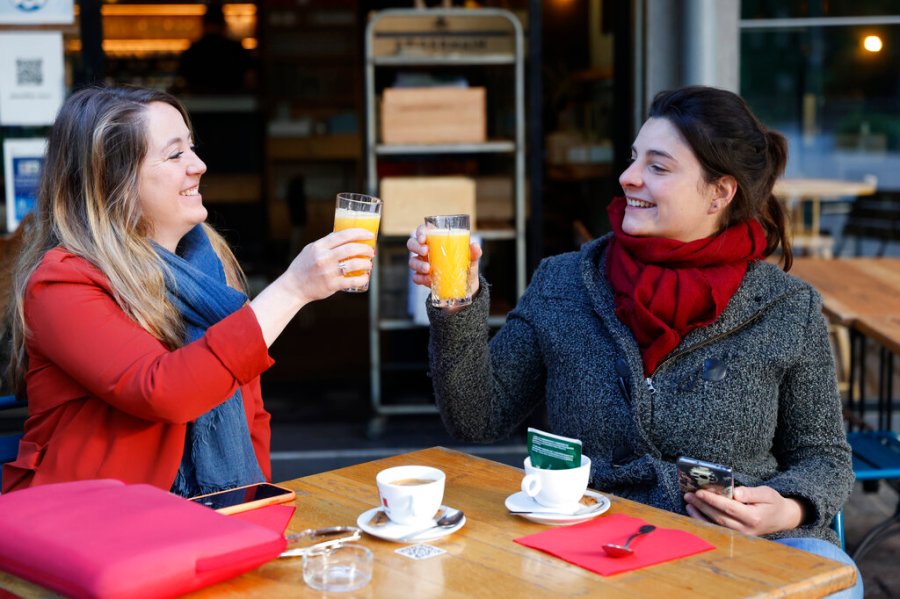 Women enjoy a cafe and an orange juice at a café terrace Wednesday, May, 19, 2021 in Strasbourg, eastern France. (AP Photo/Jean-Francois Badias)