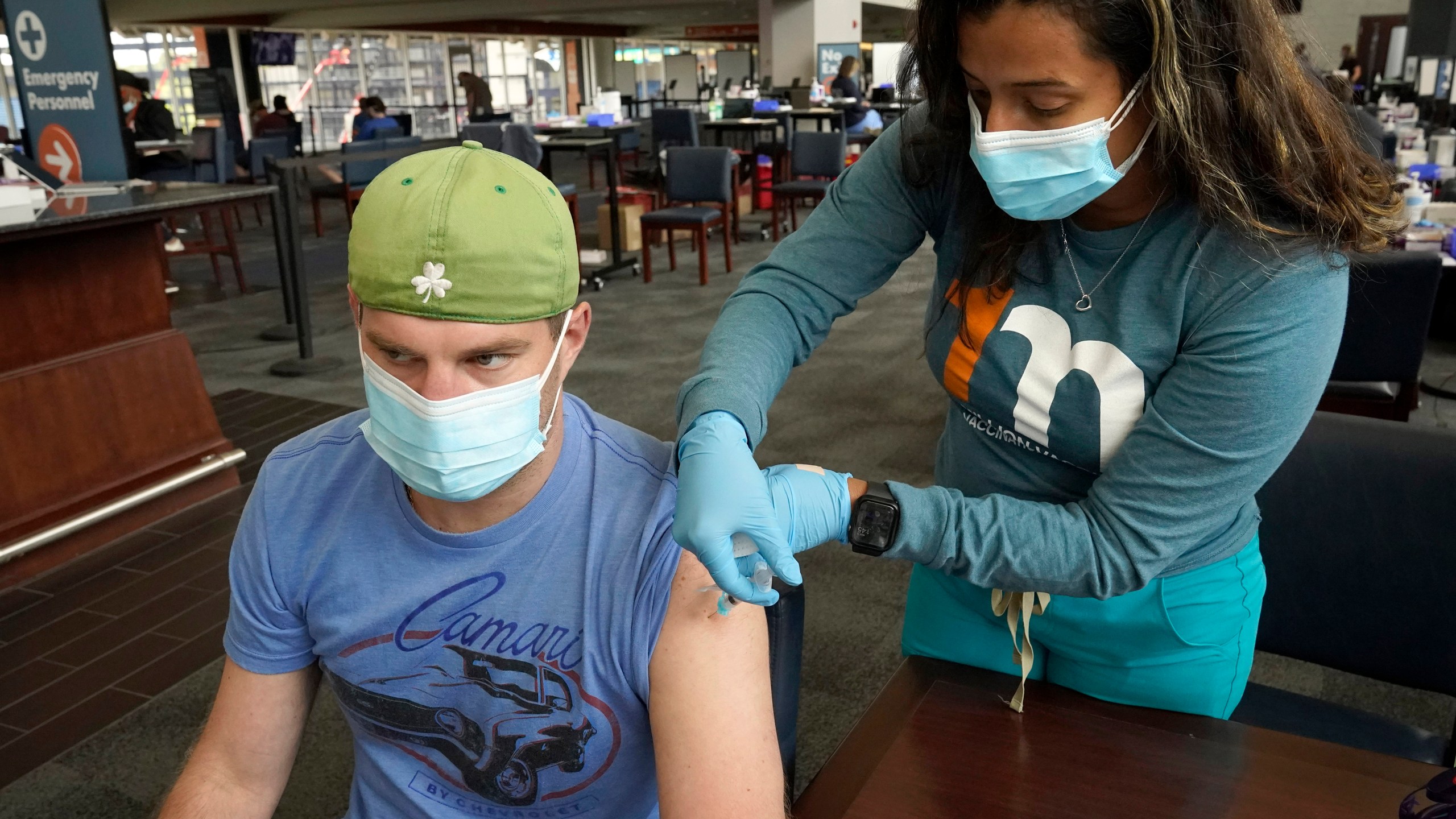 Kevin Fisher, of Quincy, Mass., left, receives his second shot of Moderna COVID-19 vaccine from RN Katherine Francisco, of Avon, Mass., right, at a mass vaccination clinic on May 19, 2021, at Gillette Stadium, in Foxborough, Mass. (Steven Senne/Associated Press)