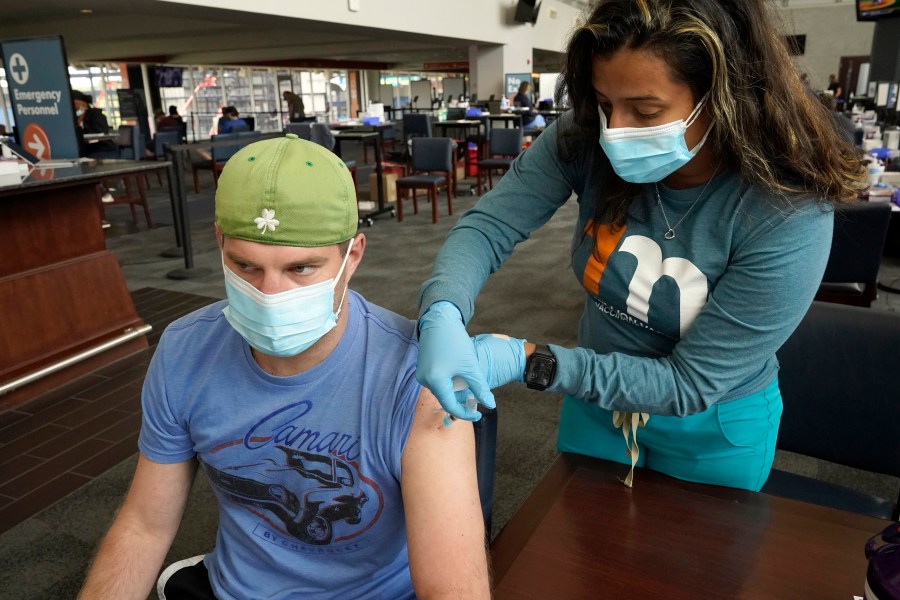 Kevin Fisher, of Quincy, Mass., left, receives his second shot of Moderna COVID-19 vaccine from RN Katherine Francisco, of Avon, Mass., right, at a mass vaccination clinic on May 19, 2021, at Gillette Stadium, in Foxborough, Mass. (Steven Senne/Associated Press)