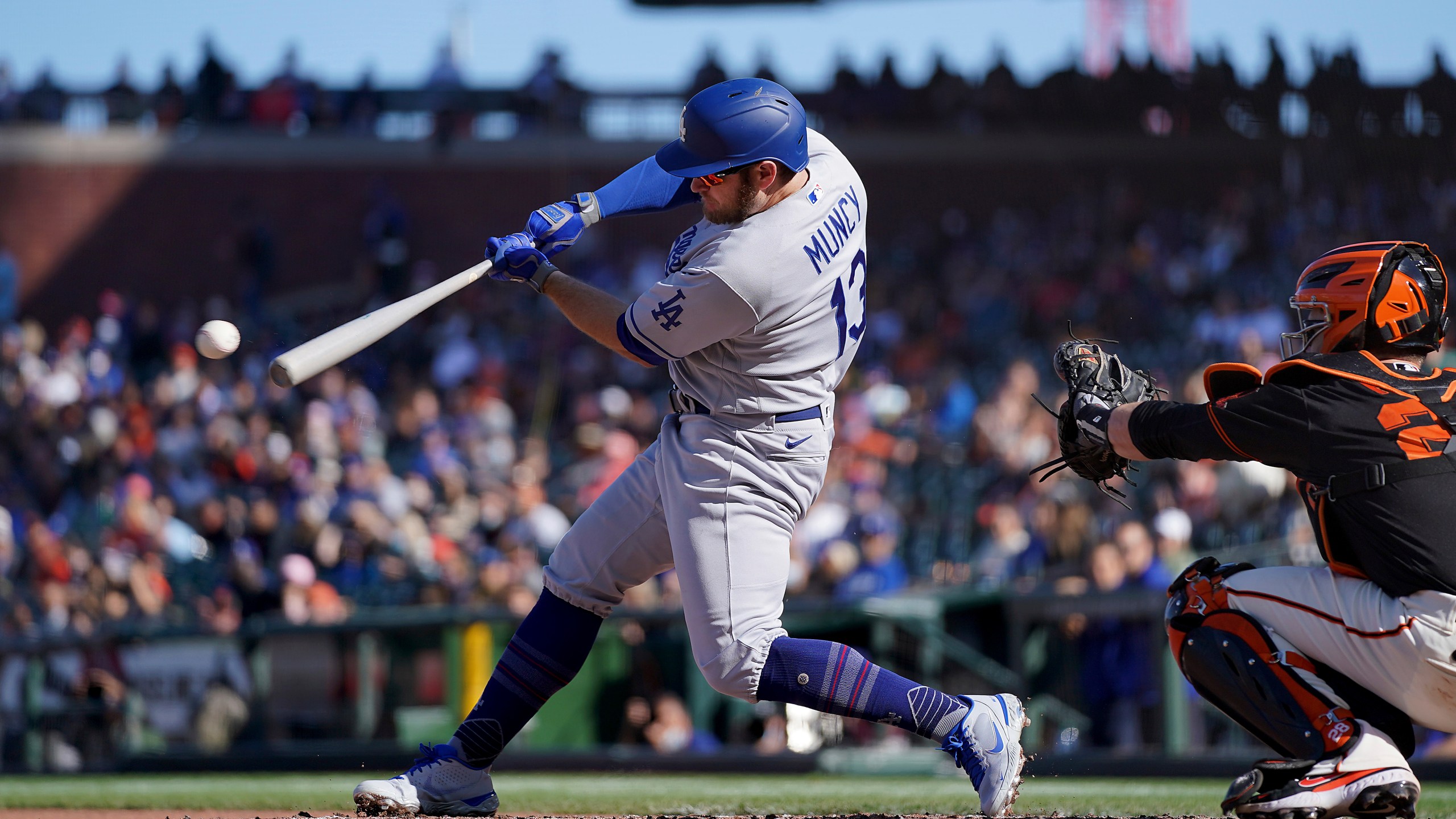 Los Angeles Dodgers' Max Muncy (13) hits a single against the San Francisco Giants during the fourth inning of a baseball game Saturday, May 22, 2021, in San Francisco. (AP Photo/Tony Avelar)